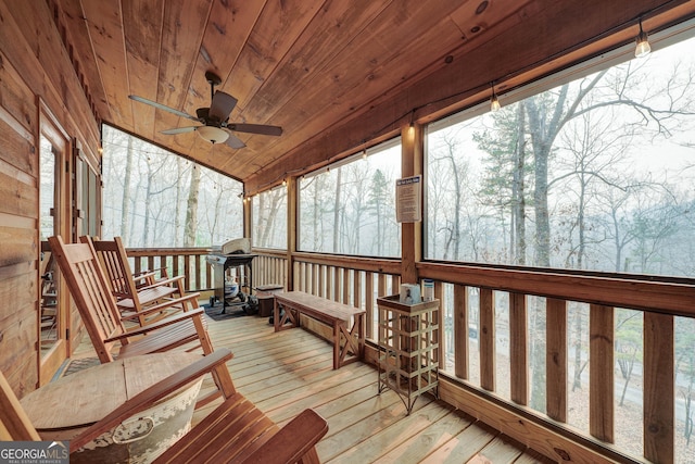 wooden terrace featuring a ceiling fan