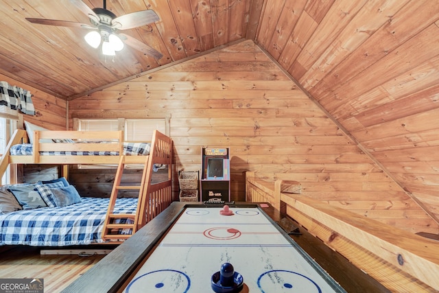 bedroom featuring lofted ceiling, wooden ceiling, and wooden walls