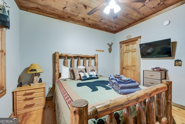bedroom featuring wood finished floors, wooden ceiling, baseboards, and ceiling fan