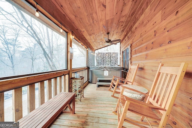 wooden deck featuring a hot tub and ceiling fan