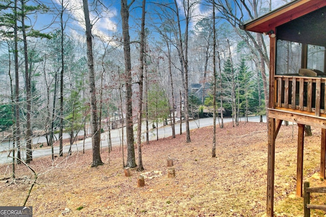 view of yard featuring a forest view