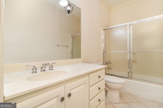 bathroom featuring crown molding, bath / shower combo with glass door, toilet, tile patterned floors, and vanity