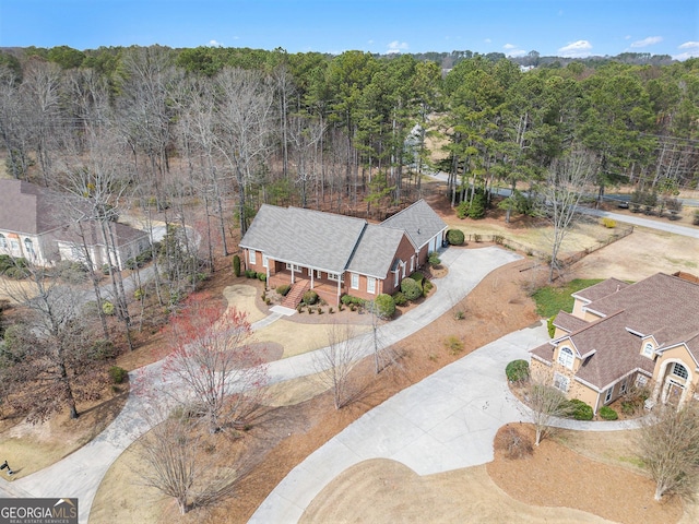 drone / aerial view featuring a forest view