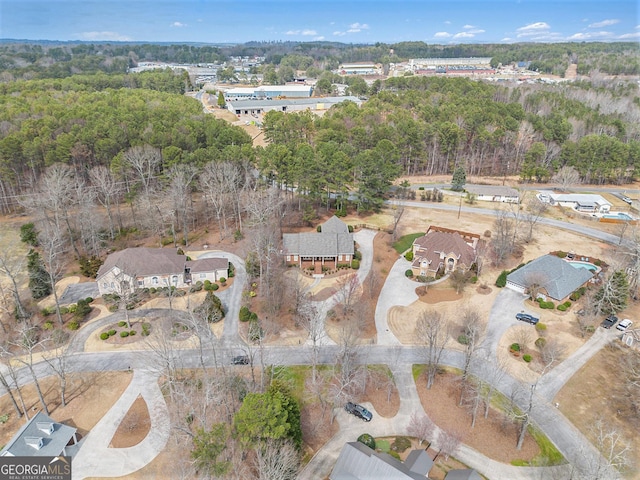 drone / aerial view featuring a wooded view