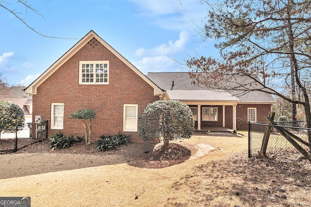 exterior space with fence and brick siding