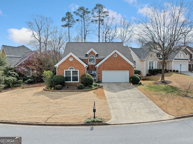 traditional-style house featuring a garage, brick siding, and driveway