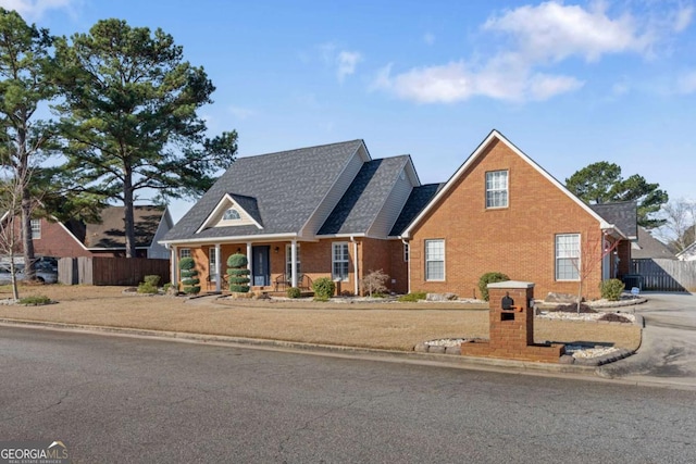 view of front of home with fence and brick siding