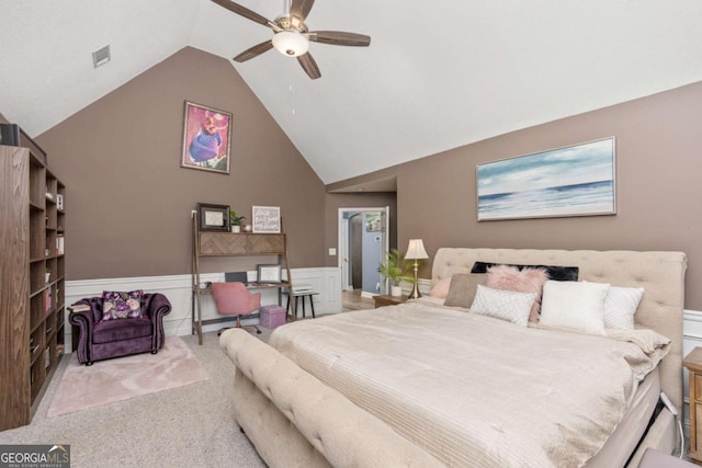 bedroom with visible vents, a wainscoted wall, high vaulted ceiling, a ceiling fan, and carpet flooring