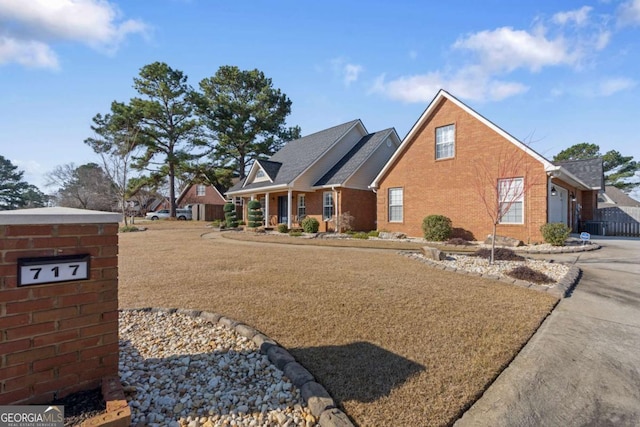 view of front of house with brick siding, an attached garage, and concrete driveway