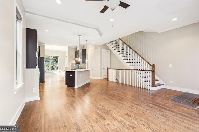 1199 Huff Rd Unit 121, Atlanta, GA 30318 - unfurnished living room with wood finished floors, stairway, a ceiling fan, and recessed lighting