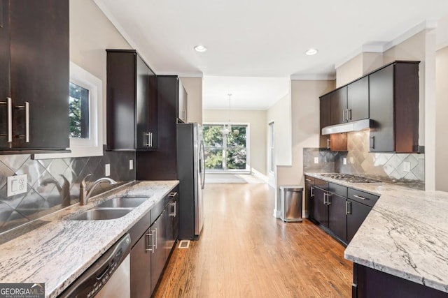 1199 Huff Rd Unit 121, Atlanta, GA 30318 - kitchen with appliances with stainless steel finishes, light wood finished floors, light stone counters, ornamental molding, and under cabinet range hood