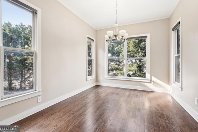 1199 Huff Rd Unit 121, Atlanta, GA 30318 - unfurnished dining area with a chandelier, plenty of natural light, and wood finished floors