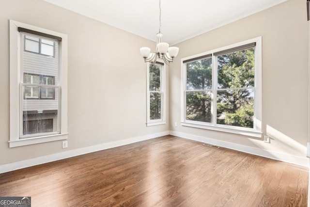 1199 Huff Rd Unit 121, Atlanta, GA 30318 - unfurnished dining area with a chandelier and wood finished floors