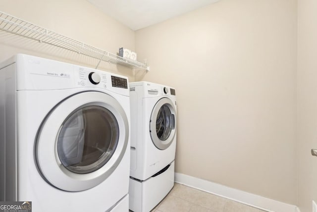 1199 Huff Rd Unit 121, Atlanta, GA 30318 - laundry area featuring washer and dryer and light tile patterned floors