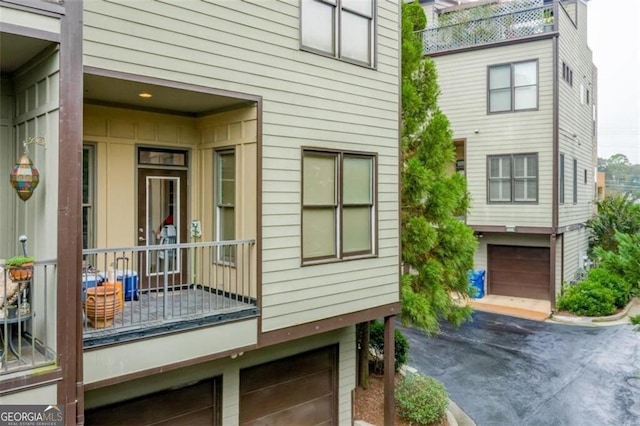 1199 Huff Rd Unit 121, Atlanta, GA 30318 - rear view of house with a garage and driveway