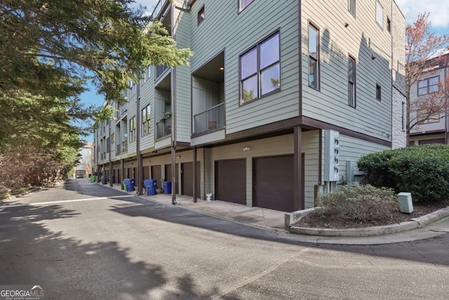 1199 Huff Rd Unit 121, Atlanta, GA 30318 - view of building exterior featuring a garage