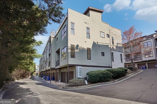 1199 Huff Rd Unit 121, Atlanta, GA 30318 - view of property featuring a garage and driveway