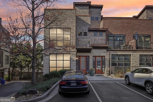 1199 Huff Rd Unit 121, Atlanta, GA 30318 - view of front of house with stone siding and uncovered parking