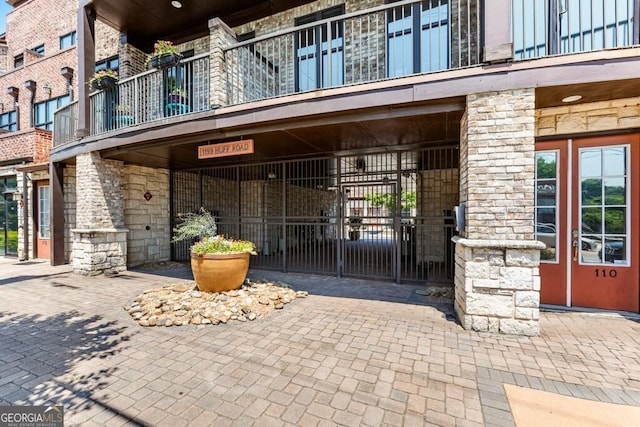 1199 Huff Rd Unit 121, Atlanta, GA 30318 - entrance to property featuring stone siding and a balcony