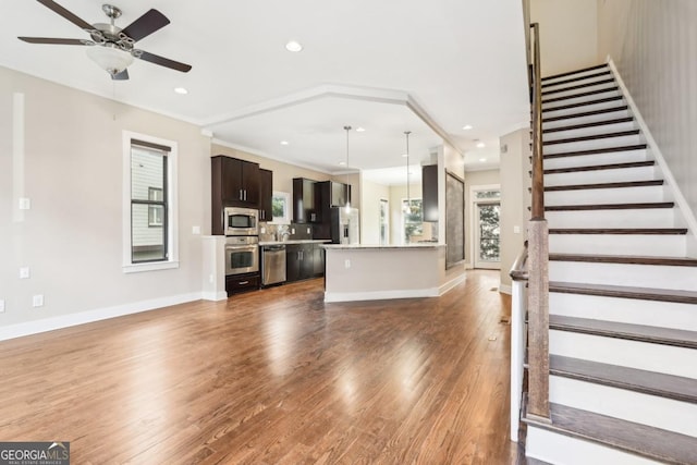 1199 Huff Rd Unit 121, Atlanta, GA 30318 - unfurnished living room featuring a ceiling fan, wood finished floors, recessed lighting, and stairs