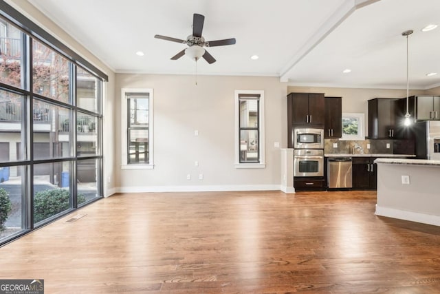 1199 Huff Rd Unit 121, Atlanta, GA 30318 - kitchen featuring stainless steel appliances, healthy amount of natural light, light wood finished floors, crown molding, and recessed lighting