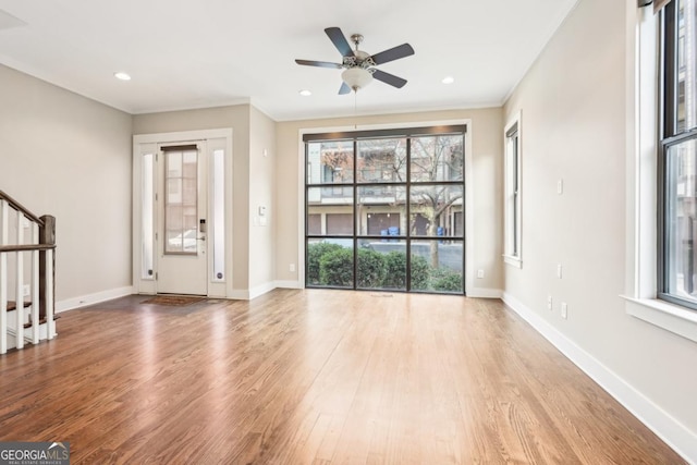 1199 Huff Rd Unit 121, Atlanta, GA 30318 - entryway featuring plenty of natural light, wood finished floors, stairs, a ceiling fan, and ornamental molding