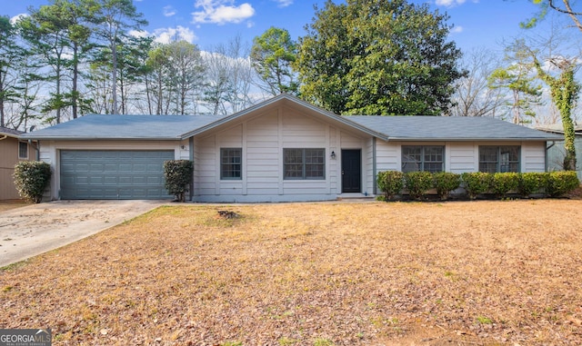 single story home featuring concrete driveway and a garage