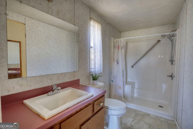 bathroom featuring curtained shower, a textured ceiling, vanity, and toilet