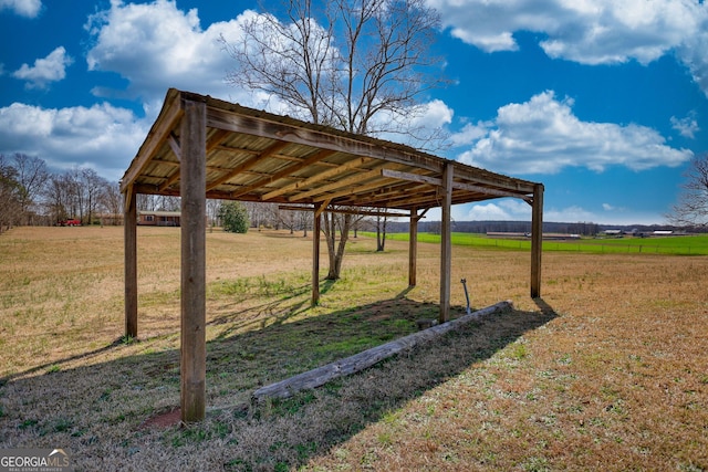 view of yard featuring a carport and a rural view