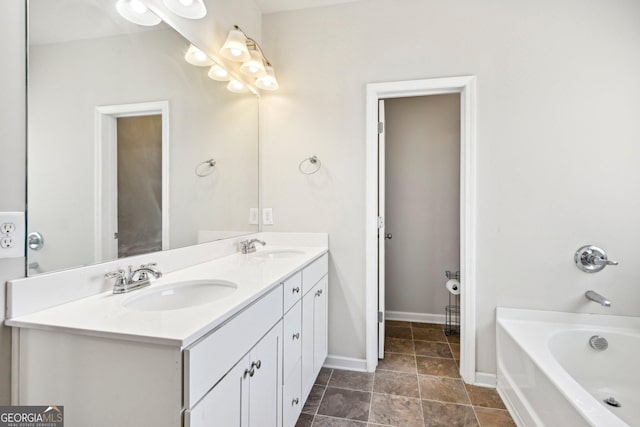 bathroom featuring double vanity, a tub, baseboards, and a sink