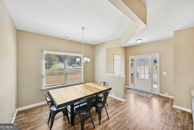 dining room with an inviting chandelier, wood finished floors, and baseboards