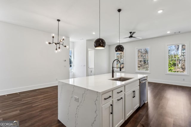 kitchen featuring a sink, stainless steel dishwasher, dark wood-style flooring, and ceiling fan with notable chandelier