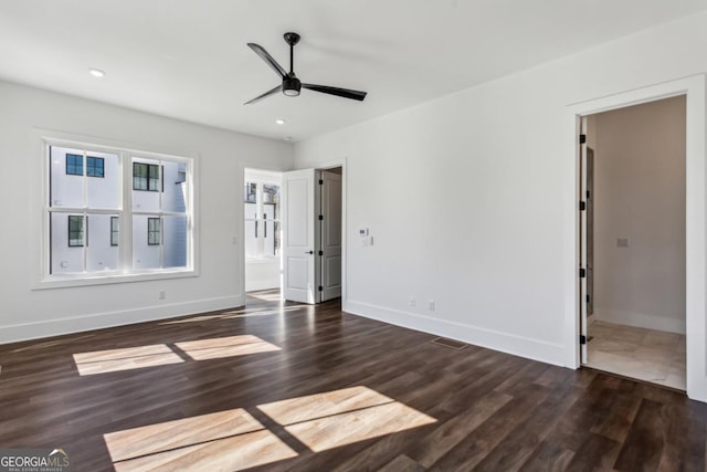 interior space with ensuite bath, wood finished floors, recessed lighting, baseboards, and ceiling fan