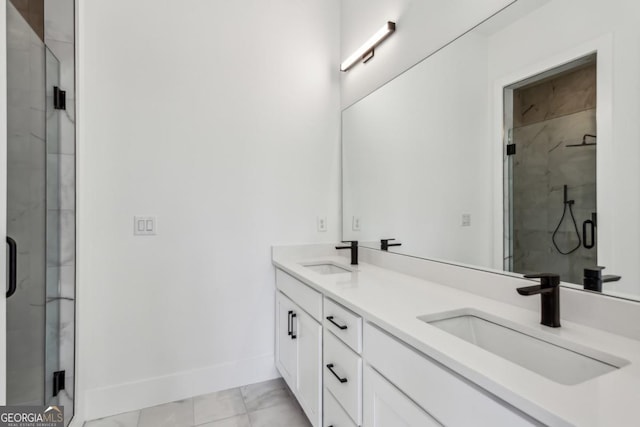 bathroom with double vanity, a stall shower, and a sink