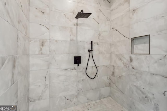 bathroom with a tile shower