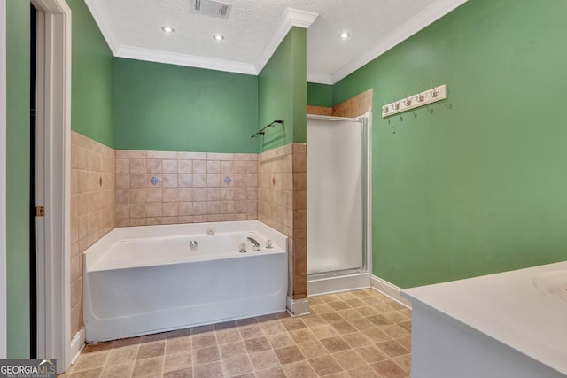 full bathroom featuring visible vents, a garden tub, ornamental molding, a stall shower, and a textured ceiling