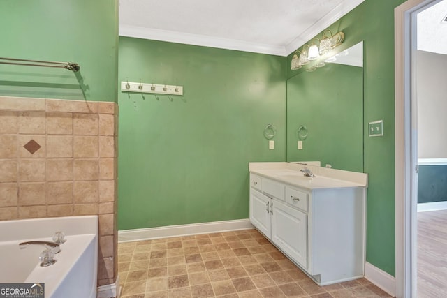 bathroom with baseboards, a garden tub, vanity, and crown molding