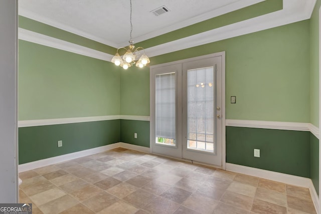 empty room with a chandelier, visible vents, french doors, and baseboards