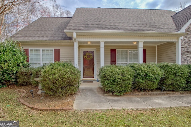 view of front of home featuring roof with shingles