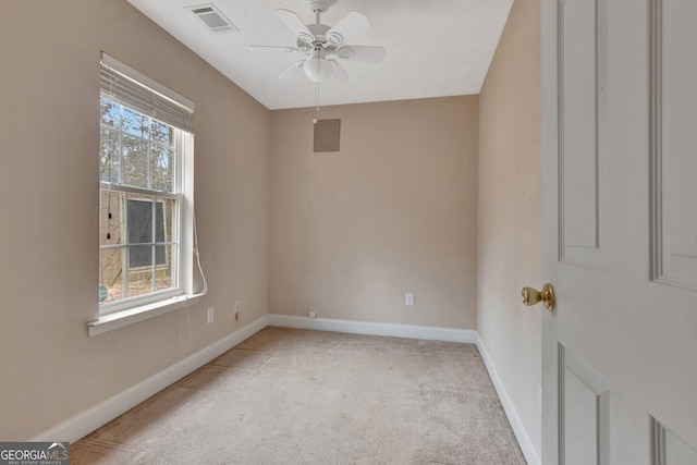 unfurnished room featuring visible vents, baseboards, light colored carpet, and a ceiling fan