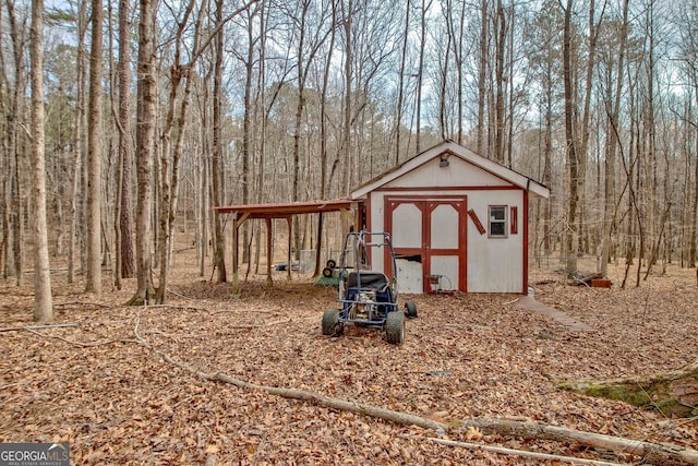 view of shed with a forest view