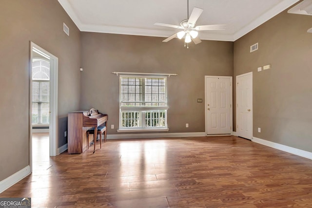 interior space with baseboards, wood finished floors, a healthy amount of sunlight, and ceiling fan