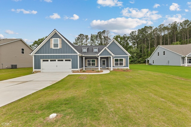 view of front of property featuring board and batten siding, concrete driveway, central AC, and a front yard