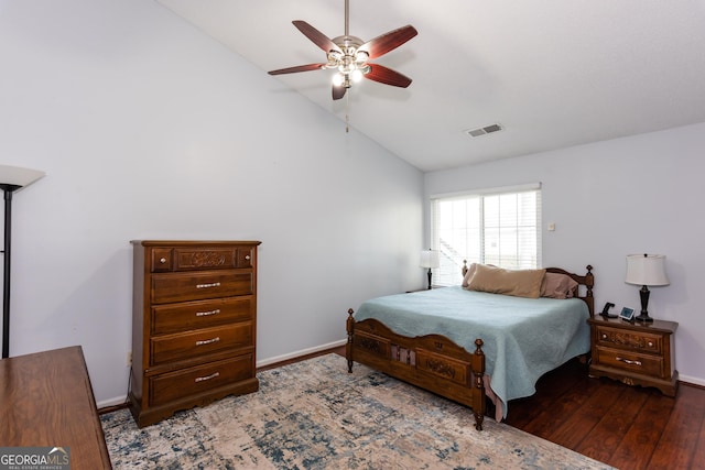 bedroom with visible vents, baseboards, lofted ceiling, and wood finished floors