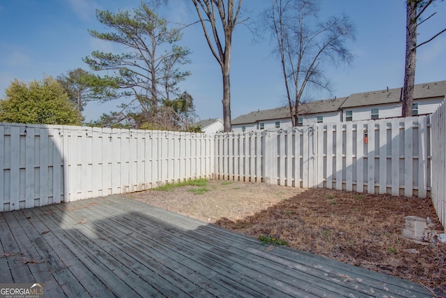 wooden terrace featuring a fenced backyard