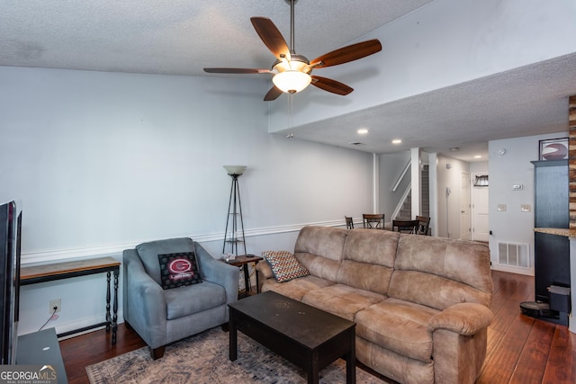 living area with wood finished floors, a ceiling fan, visible vents, and a textured ceiling