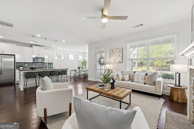 living area featuring dark wood finished floors, recessed lighting, a ceiling fan, and visible vents