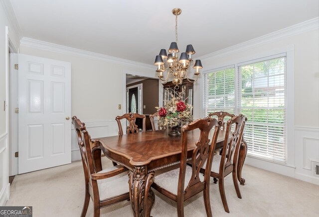 2205 Parliament Dr, Lawrenceville, GA 30043 - dining space featuring light carpet, a chandelier, ornamental molding, a decorative wall, and wainscoting