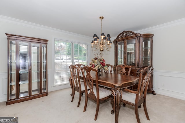 2205 Parliament Dr, Lawrenceville, GA 30043 - dining space featuring a chandelier, light colored carpet, ornamental molding, and wainscoting
