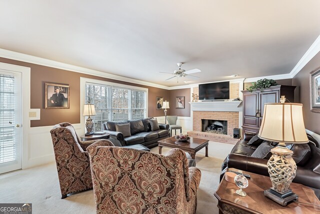 2205 Parliament Dr, Lawrenceville, GA 30043 - living room with light colored carpet, ceiling fan, ornamental molding, wainscoting, and a fireplace